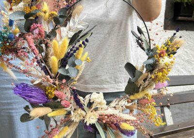 a woman holding a wreath of flowers